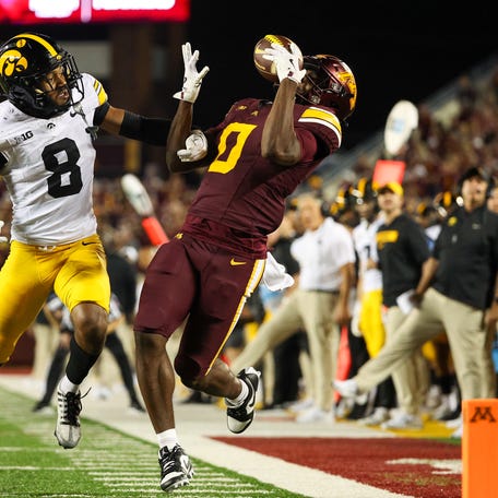 Sep 21, 2024; Minneapolis, Minnesota, USA; Minnesota Golden Gophers wide receiver Le'Meke Brockington (0) catches a pass as Iowa Hawkeyes defensive back Deshaun Lee (8) defends during the first half at Huntington Bank Stadium. Mandatory Credit: Matt Krohn-Imagn Images