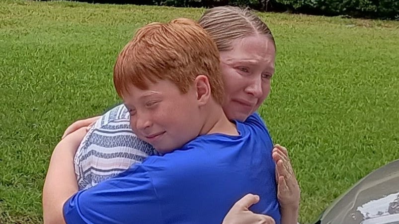 Everett Higgins, 9, embraced his mother, Kelley Hughes, after they were reunited following a catastrophic flood in Kerr County, Texas, on July 4. Higgins was one of hundreds of children who were evacuated from Camp La Junta.