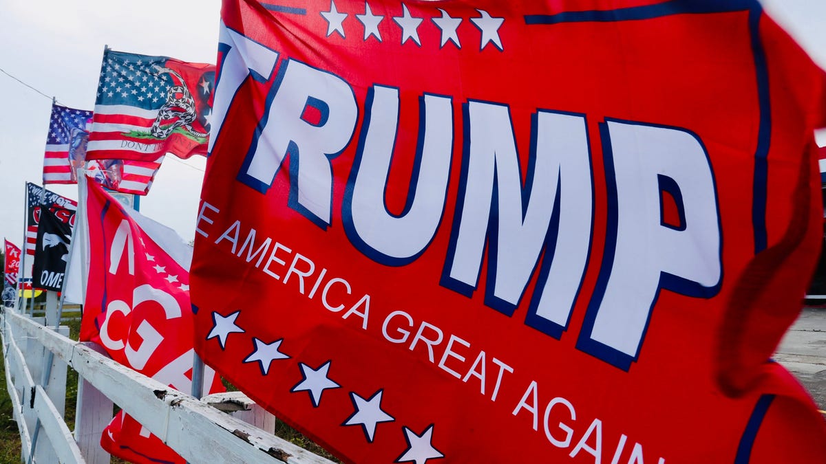 Trump flags whip in the wind at the Trump MAGA Superstore on U.S. 1 near Interstate 95 in Ormond Beach on Wednesday, Nov. 6, 2024.