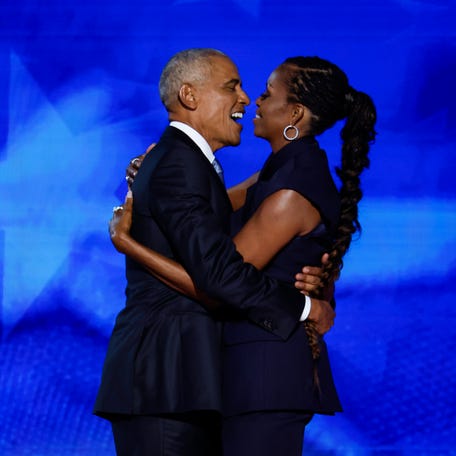 Barack Obama and Michelle Obama as he arrives to speak on stage during the second day of the Democratic National Convention at the United Center on Aug. 20, 2024, in Chicago.