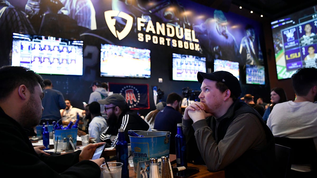 Seamus Magee, right, and Anthony Mea, both of Hoboken, New Jersey, watch the first games of the NCAA basketball tournament at the Meadowlands Racetrack, where sports fans can legally bet on March Madness games for the first time in New Jersey on March 21, 2019, in East Rutherford.