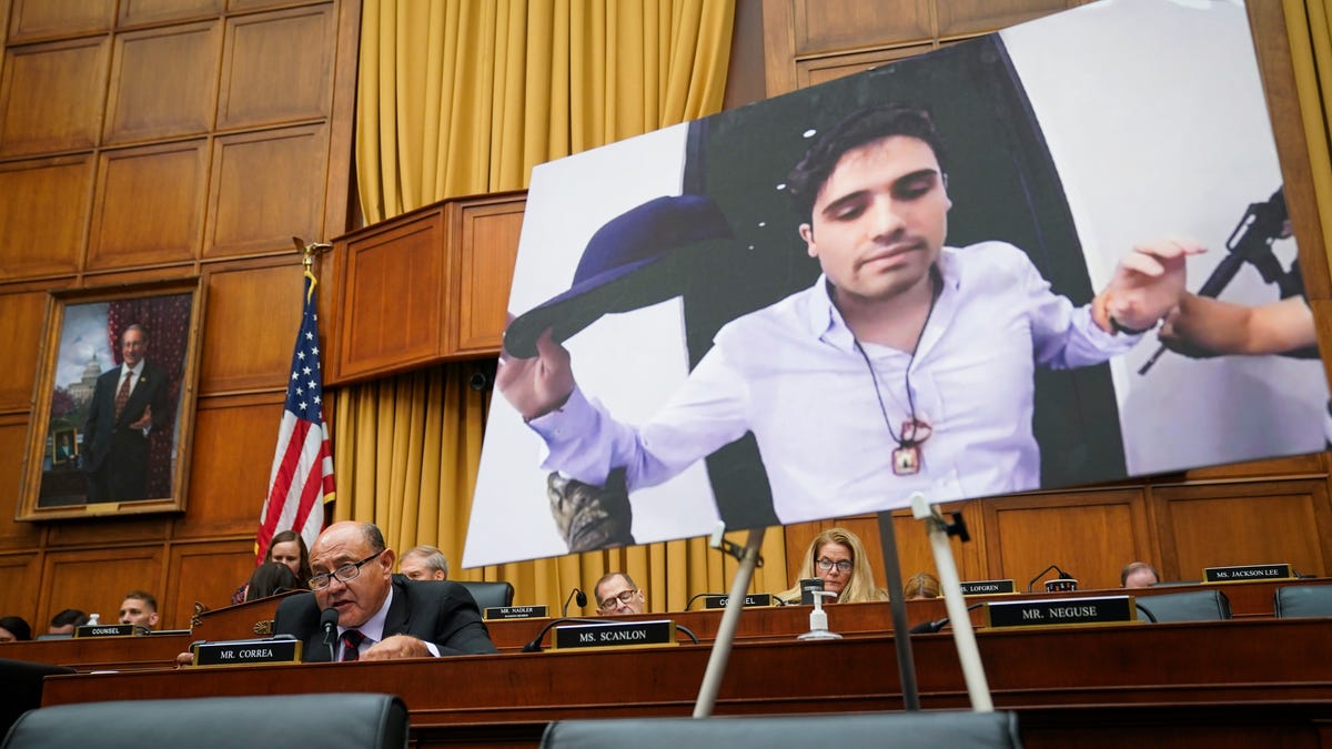 In Washington, D.C., Rep. Lou Correa, (D-CA) shows in 2023 a photograph of Ovidio Guzman Lopez, a son of former Sinaloa cartel leader Joaquin "El Chapo" Guzmán, who was extradited to the U.S from Mexico.