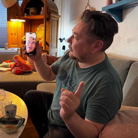 Jorgen Boassen speaks to a friend from his home in Nuuk, Greenland.