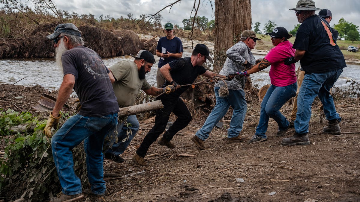 Search and recovery crews remove debris from the bank of the Guadalupe River on July 9, 2025 in Center Point, Texas. More than 170 people are still missing after deadly flash floods in central Texas, with at least 119 people reported dead.