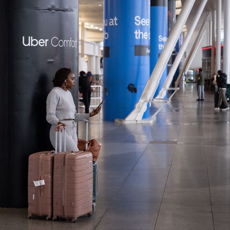 A person makes a phone call after arriving at John F. Kennedy International Airport on June 9, 2025 in New York City.