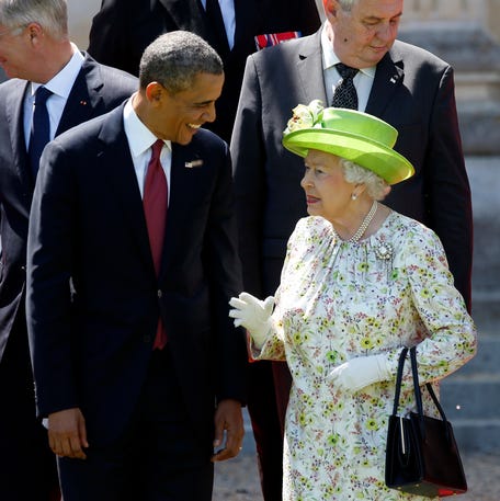 President Barack Obama talks with Britain's Queen Elizabeth during the 70th anniversary of the D-Day landings in Benouville, France, on June 6, 2014.