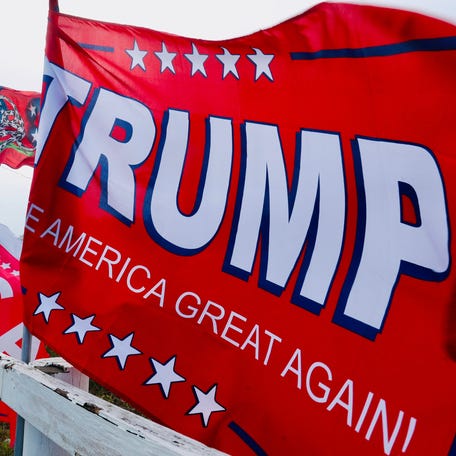 Trump flags whip in the wind at the Trump MAGA Superstore on U.S. 1 near Interstate 95 in Ormond Beach on Wednesday, Nov. 6, 2024.