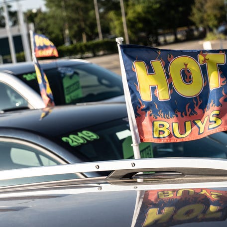 Pre-owned cars and trucks are parked in a lot at Gordon Chevrolet in Garden City on Monday, August 23, 2021.