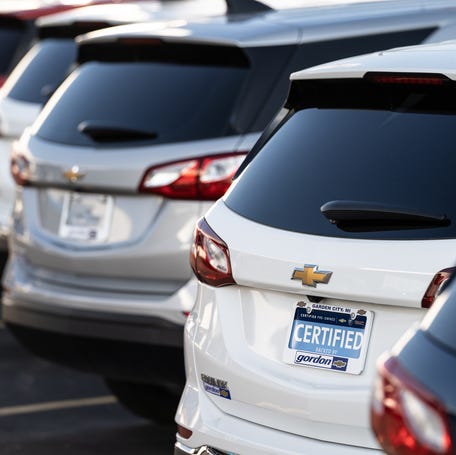 Pre-owned cars and trucks are parked in a lot at Gordon Chevrolet in Garden City on Monday, August 23, 2021.