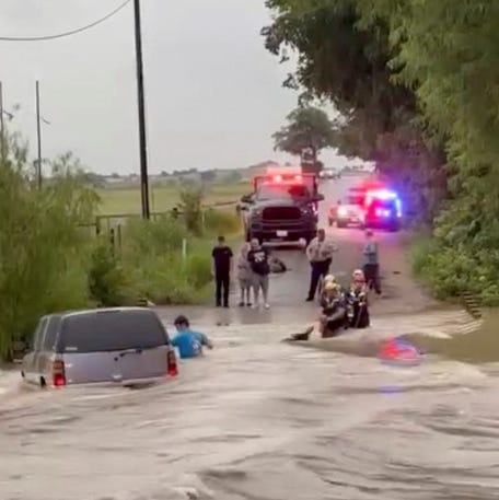 Rescuers help a stranded person amid flooding in McGregor, Texas, on July 13, 2025, in this screen grab taken from a video.
