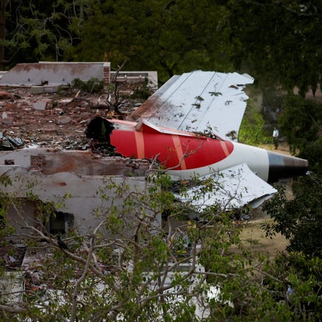 Tail of an Air India Boeing 787 Dreamliner plane that crashed is seen stuck on a building after the incident in Ahmedabad, India, June 12, 2025.