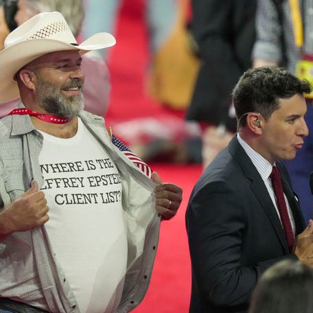 An attendee flashes a shirt reading 