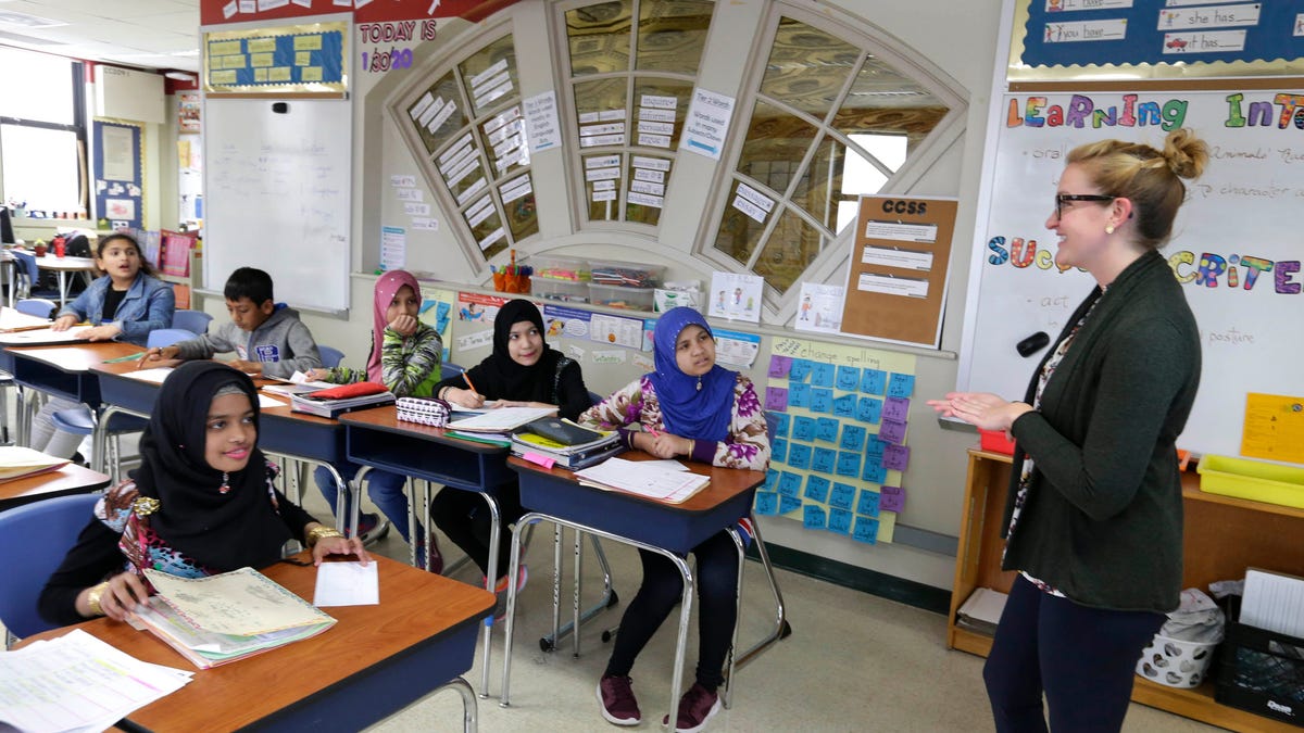Teacher Erin Sivek is seen working with students at Milwaukee Public Schools' International Newcomer Center. The program marries ESL with subject matter content to help kick-start the language acquisition and academic progress of the mostly refugee students who attend.
