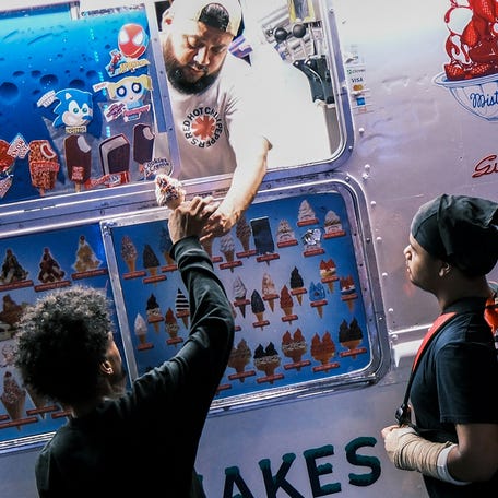 Young boys buy ice cream from a truck in the Sugar Hill neighborhood of Manhattan, New York City, on July 10, 2025.