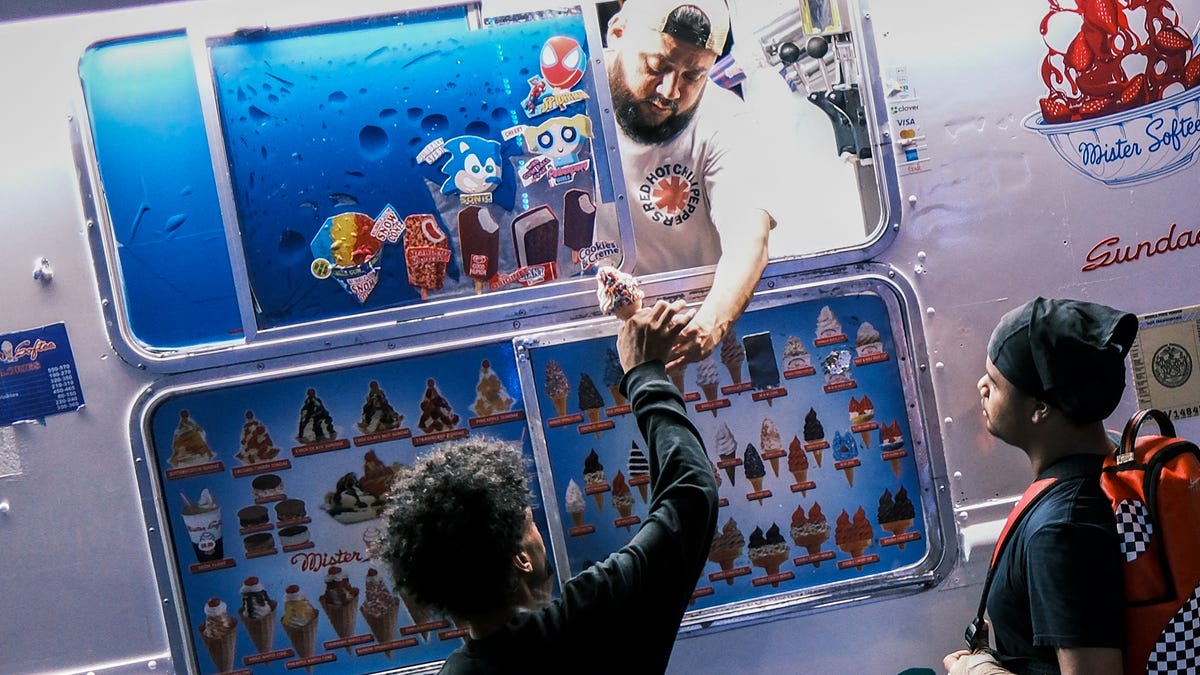 Young boys buy ice cream from a truck in the Sugar Hill neighborhood of Manhattan, New York City, on July 10, 2025.