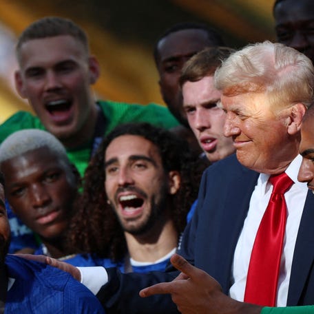Chelsea's Reece James and teammates celebrate with the trophy alongside President Donald Trump after winning the FIFA Club World Cup on at MetLife Stadium in East Rutherford, New Jersey, on July 13, 2025.