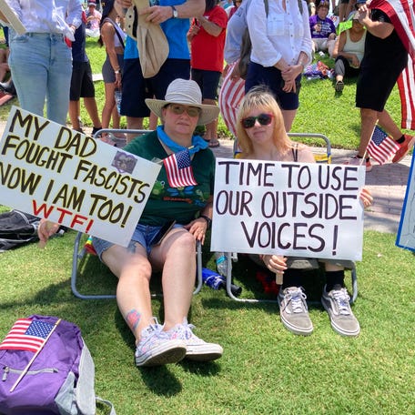 Melissa Estrada and her niece Alexis Silveira came to the 'No Kings' rally in West Palm Beach on June 14, 2025, to protest President Trump's immigration crackdown. Estrada's banner paid tribute to her father who fought in World War II.