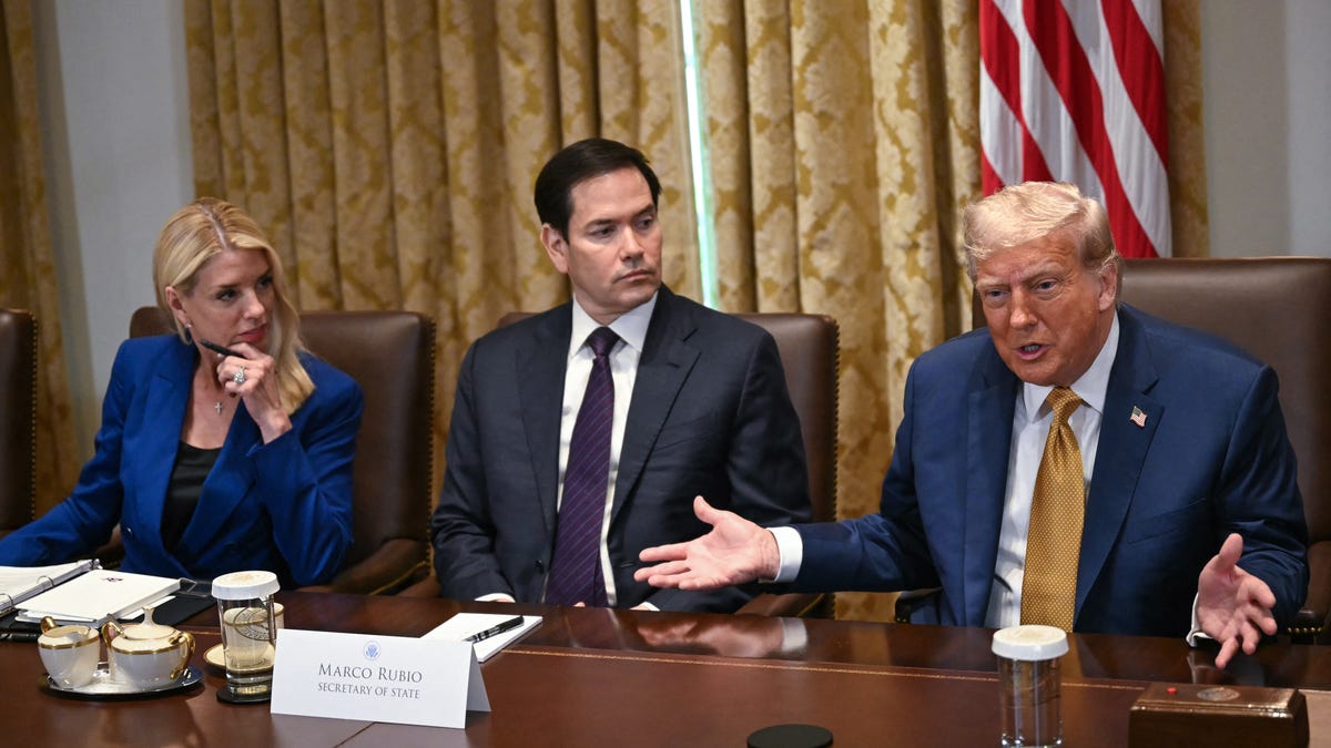 TOPSHOT - US President Donald Trump speaks as Attorney General Pam Bondi (L) and Secretary of State Marco Rubio (C) look on during a cabinet meeting in the Cabinet Room of the White House in Washington, DC, on July 8, 2025.