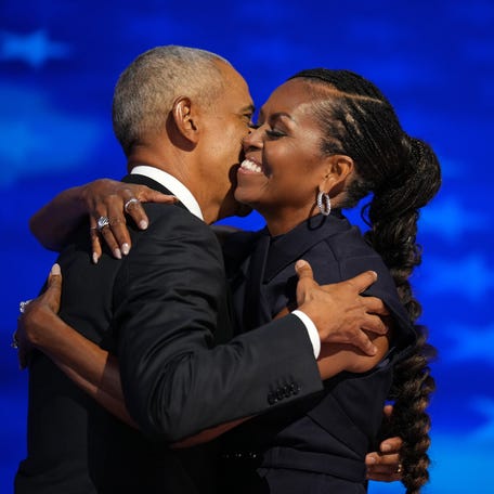 Former U.S. President Barack Obama greets former first lady Michelle Obama as he arrives to speak on stage during the second day of the Democratic National Convention at the United Center on Aug. 20, 2024, in Chicago.