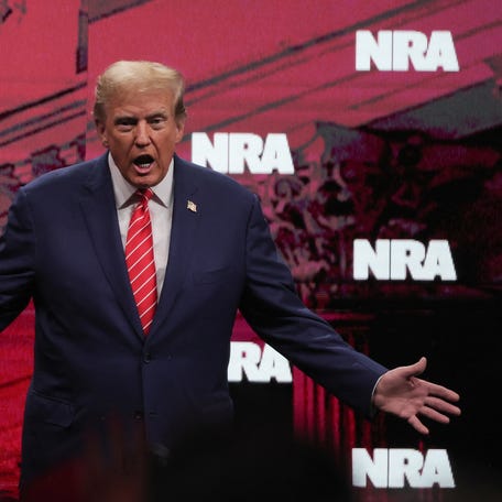Former U.S. President and Republican presidential candidate Donald Trump gestures during the annual National Rifle Association (NRA) meeting in Dallas, Texas, U.S., May 18, 2024. REUTERS/Carlos Barria