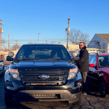 Khalil AlHajal in a Garden City auction lot after purchasing a 2014 Ford Explorer Police Interceptor in February 2024.