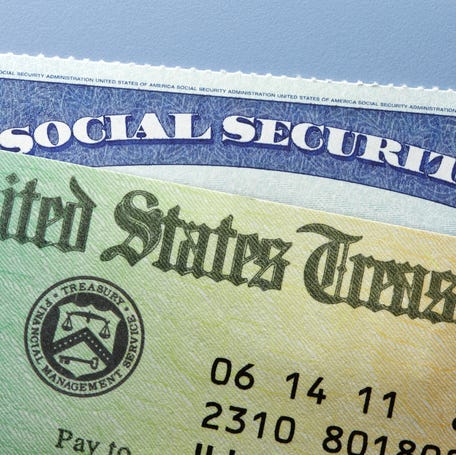 A United States Treasury government check rests on top of a Social Security card.