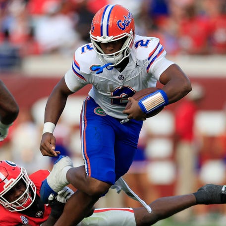 Florida quarterback DJ Lagway (2) tries to avoid the tackle of Georgia linebacker CJ Allen (3) during their 2024 game at EverBank Stadium in Jacksonville, Fla.