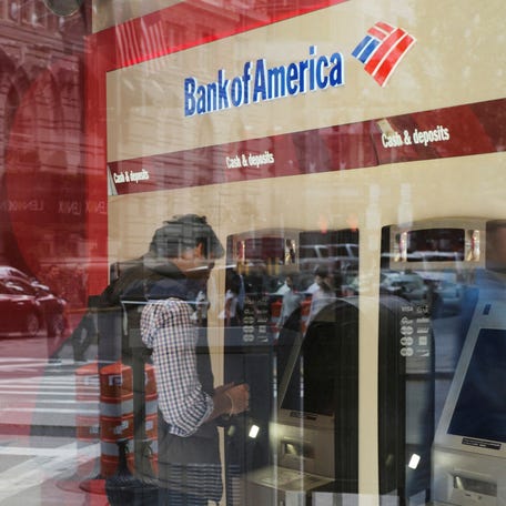 FILE PHOTO: A customer uses an ATM at a Bank of America branch in Boston, Massachusetts, U.S., October 11, 2017.