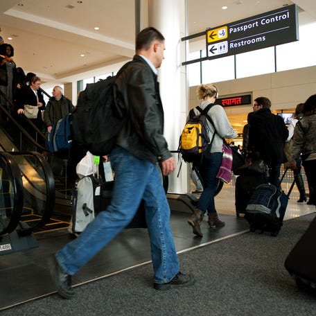 International air travelers entering the United States head to "Passport Control" inside the U.S. Customs and Immigration area at Dulles International Airport on Dec. 21, 2011.