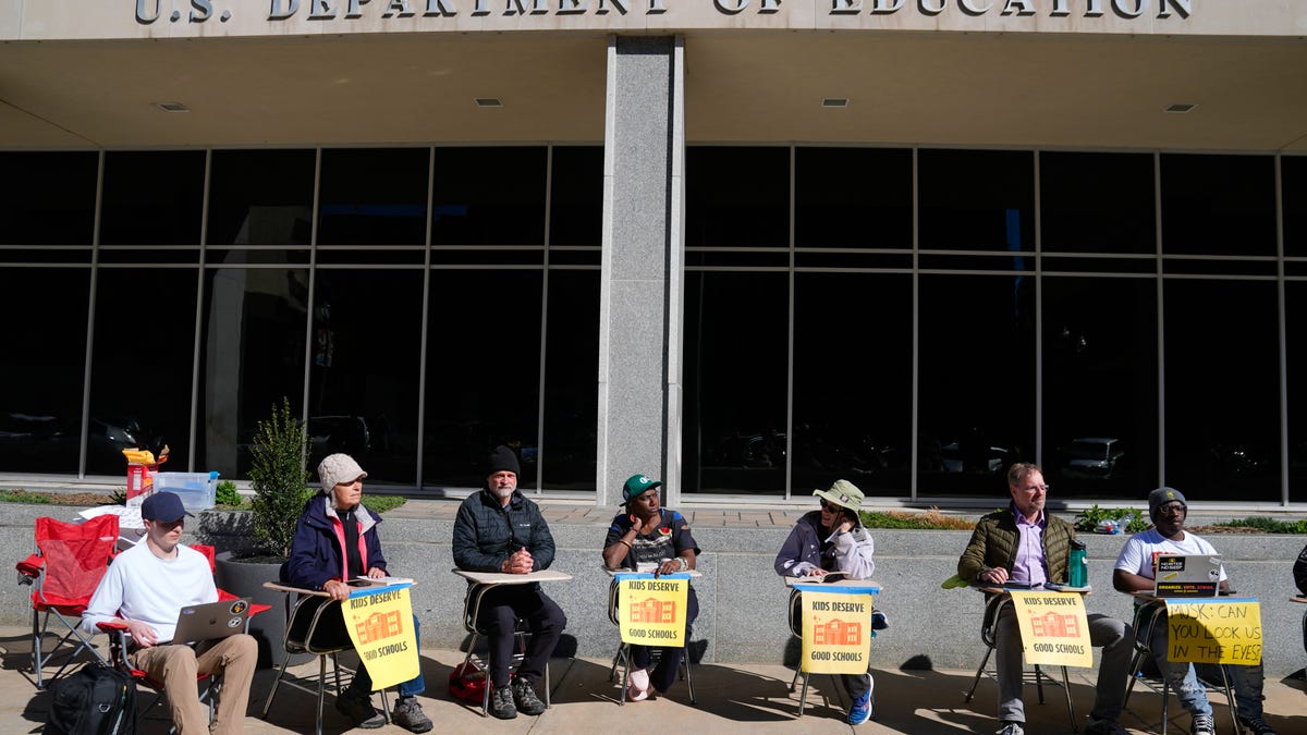 Protesters demonstrate against Education Department cuts outside the agency in Washington, D.C., on March 21, 2025. Despite President Trump's plan to eliminate it, he nominated a former for-profit college executive to a top department position overseeing universities.