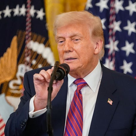 President Donald Trump is pictured speaking at the White House before signing the "Genius Act."