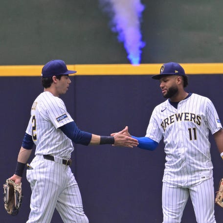 Jackson Chourio and Christian Yelich celebrate a win.