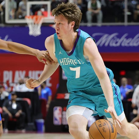 Kon Knueppel of the Charlotte Hornets drives against Matthew Cleveland of the Dallas Mavericks during the first half of a 2025 NBA Summer League game at the Thomas & Mack Center on July 14, 2025 in Las Vegas.