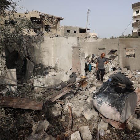 A Palestinian man checks the rubble of a residential house in Deir el-Balah in the central Gaza Strip on July 1, 2025, following overnight Israeli strikes.