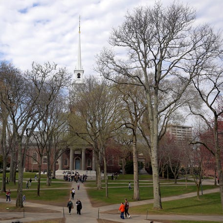 Students walk at the campus of Harvard University in Cambridge, Massachusetts on April 15, 2025.