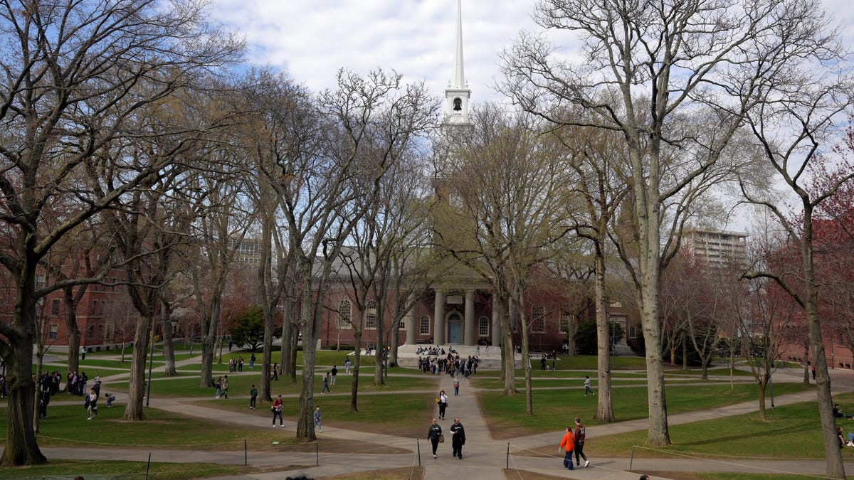 Students walk at the campus of Harvard University in Cambridge, Massachusetts on April 15, 2025.