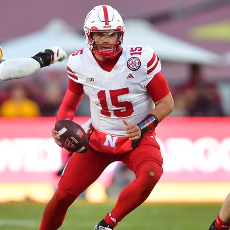 Nebraska quarterback Dylan Raiola (15) drops back to pass under pressure from Southern California linebacker Easton Mascarenas-Arnold (4) during their game at Los Angeles Memorial Coliseum.