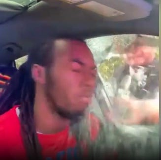William McNeil Jr. is shown as his driver's side window is broken by police during a traffic stop in February 2025.
