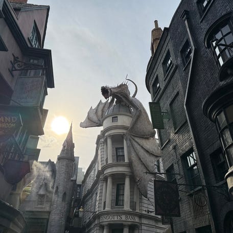 A fire-breathing dragon perches atop Gringotts Wizarding Bank in The Wizarding World of Harry Potter – Diagon Alley at Universal Studios Florida.