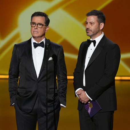 Stephen Colbert and Jimmy Kimmel speak onstage during the 71st Emmy Awards at Microsoft Theater on Sept. 22, 2019, in Los Angeles.
