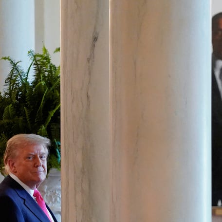 President Donald Trump looks on as the portrait of former U.S. President Barack Obama can be seen in the background at the White House in Washington, DC. on June 26, 2025.