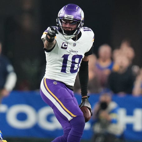 Minnesota Vikings receiver Justin Jefferson signals a first down after a catch against the Los Angeles Rams during their playoff game at State Farm Stadium.