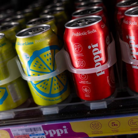 Cans of Poppi soda are displayed inside of a store on March 17, 2025 in New York City. On Monday, PepsiCo announced that it is buying prebiotic soda brand Poppi for nearly $2 billion.