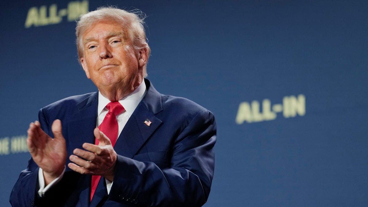 President Donald Trump applauds at the "Winning the AI Race" Summit in Washington, DC, on July 23, 2025.