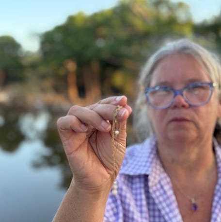Dondi Voigt Persyn holds jewelry recovered after flooding along the Guadalupe River. Persyn and two friends started a Facebook group to reunite flood victims with some of the possessions they'd lost in the July 4 flood.