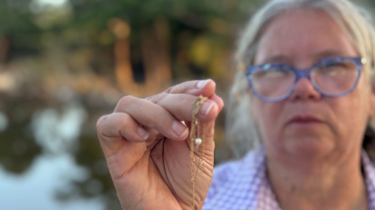 Dondi Voigt Persyn holds jewelry recovered after flooding along the Guadalupe River. Persyn and two friends started a Facebook group to reunite flood victims with some of the possessions they'd lost in the July 4 flood.