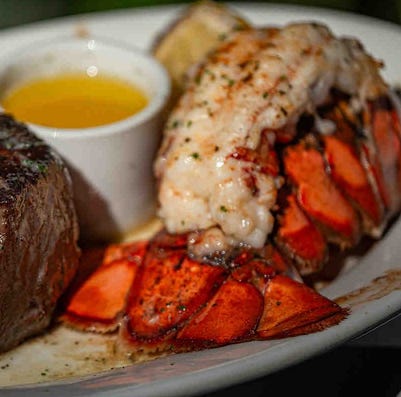 An 11-ounce filet served with lobster tail and drawn butter at Ruth's Chris Steak House at Harbourside Place in Jupiter, Fla.