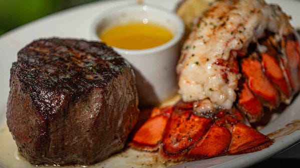 An 11-ounce filet served with lobster tail and drawn butter at Ruth's Chris Steak House at Harbourside Place in Jupiter, Fla.