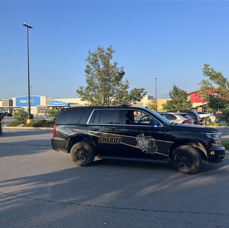 More than 10 police cars sit in the Walmart parking lot in Traverse City, Michigan, after a mass stabbing incident left 11 injured.