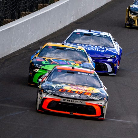 NASCAR Cup Series driver Chase Briscoe (19) leads the field of cars into the first turn during the Brickyard 400 at Indianapolis Motor Speedway.